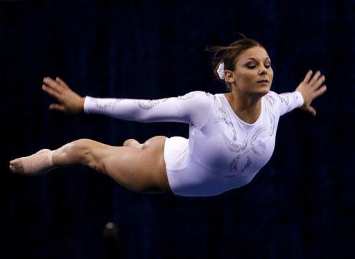 FILE - In this April 15, 2004 file photo Jamie Dantzscher performs her floor routine during preliminaries at the NCAA women's gymnastics championships in Los Angeles. Dantzscher a 2000 Olympian is one of dozens of women and girls, that have filed civil lawsuits against Dr. Larry Nassar a former Michigan State University doctor who specialized in treating elite U.S. gymnasts. Nassar was charged Wednesday, Feb. 22, 2017 with sexually assaulting nine girls, in a court in Ingham County, Mich. (AP Photo/Kevork Djansezian, File)