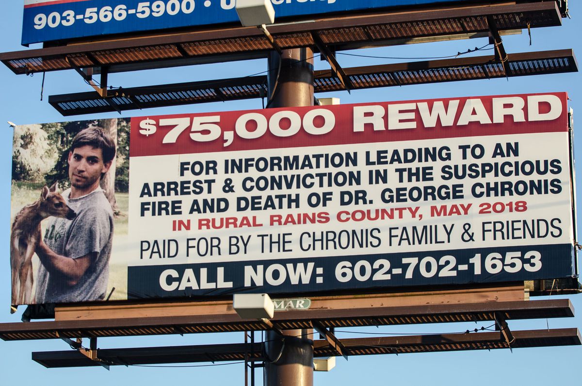 A billboard on U.S. 69 in Alba, Texas, offers a $75,000 reward for information leading to an arrest and conviction in the death of Dr. George Chronis, a 57-year-old obstetrician and gynecologist from Palos Park, found dead on his remote property in Rains County, Texas, on May 4, 2018.