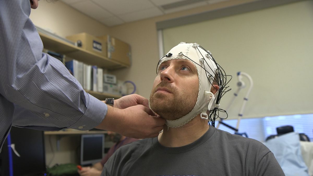 Zach Ault is fitted with an EEG cap which uses electrodes to track the electrical activity of his brain, at the National Institutes of Health’s hospital in Bethesda, Maryland. Ault has ME/CFS, what once was called “chronic fatigue syndrome,” and is part of a unique study aiming to uncover clues to how the mysterious disease steals patients’ energy.