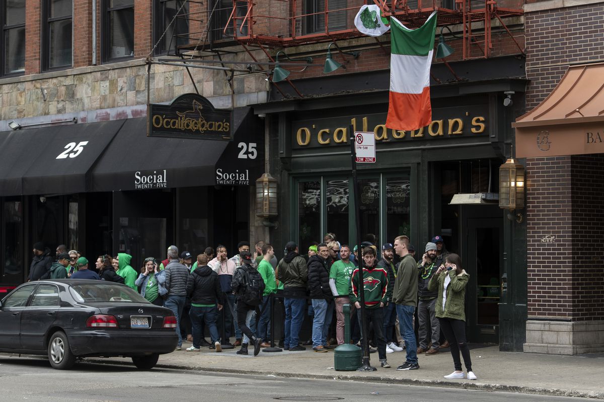 People celebrate St. Patrick’s Day outside O’Callaghan’s in River North on Saturday, even though the annual St. Patrick’s Day parades were cancelled.