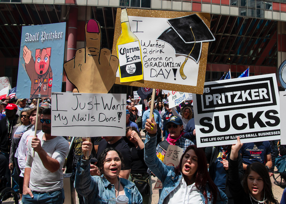 Reopen Illinois protesters pictured Saturday in the Loop. Some signs compared Gov. J.B. Pritzker to Adolf Hitler.