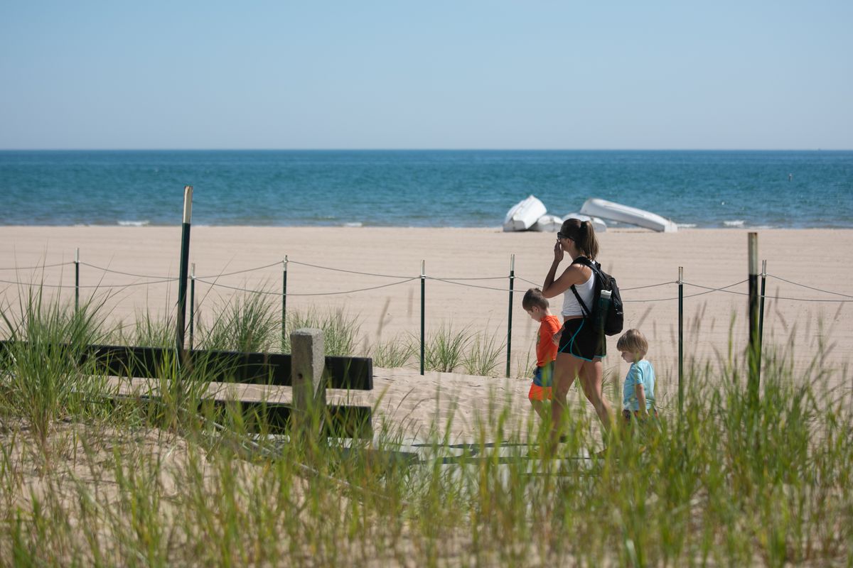 A family enjoys Friday’s gorgeous weather with a walk along the Lakefront Trail near Foster Beach in Edgewater.