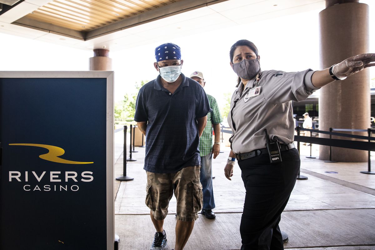 Security guards ask guests a series of questions and enforce face mask requirements at Rivers Casino in Des Plaines on the first day of reopening following an unprecedented three-month shutdown due to the coronavirus pandemic.
