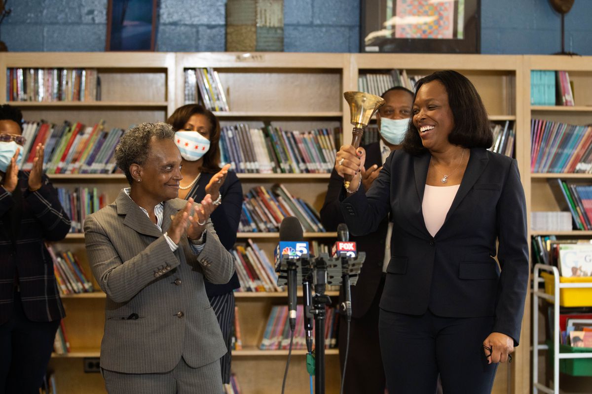 Chicago Mayor Lori Lightfoot claps as Chicago Public Schools CEO Dr. Janice Jackson rings a bell at Dr. Martin Luther King, Junior Academy of Social Justice in Englewood on the first day back to school Tuesday morning, Sept. 8, 2020.