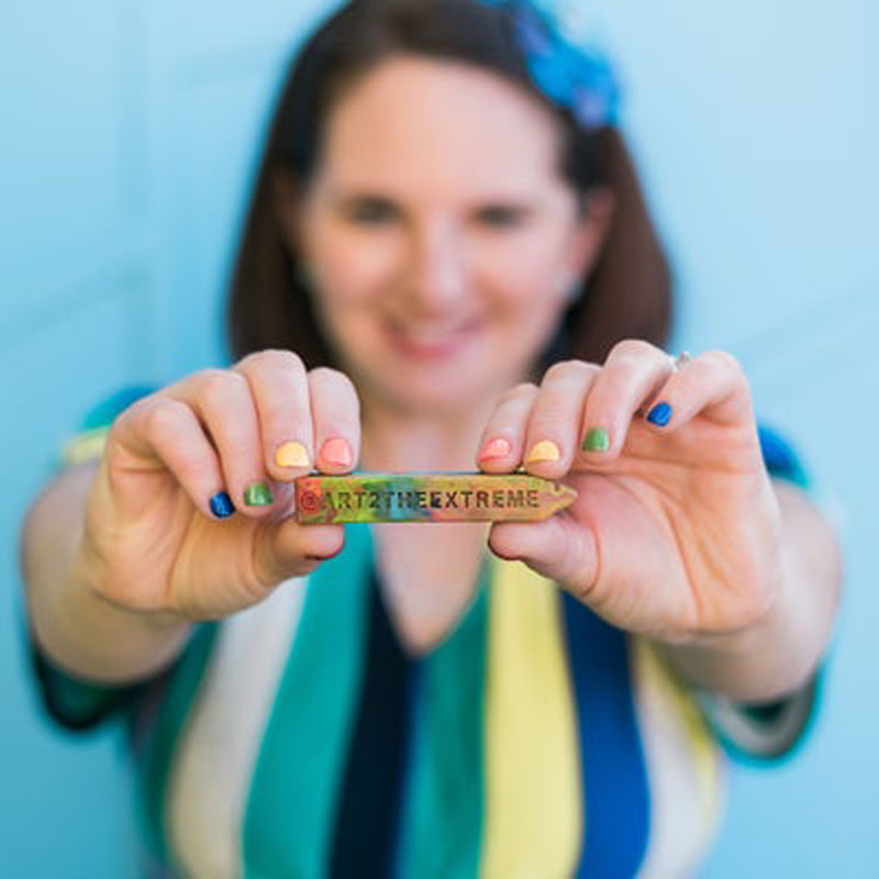 Nicole Lewis shows off one of her crayon creations.