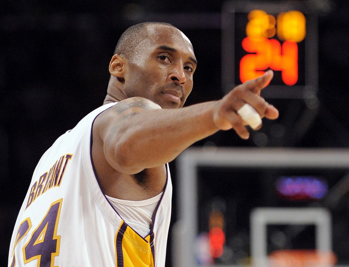 In this June 7, 2009, file photo, Los Angeles Lakers guard Kobe Bryant (24) points to a player behind him after making a basket in the closing seconds against the Orlando Magic in Game 2 of the NBA basketball finals, in Los Angeles.