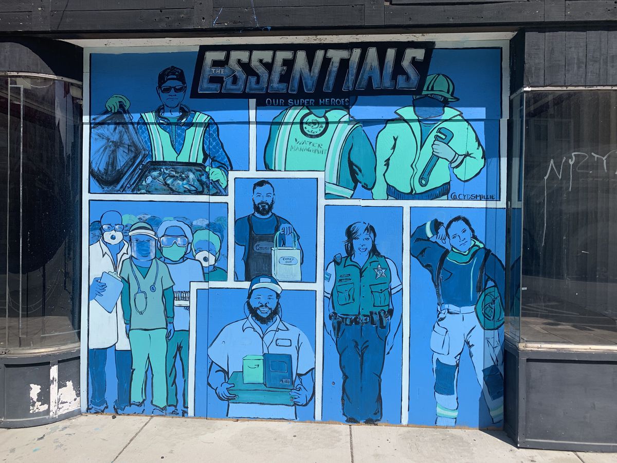 This mural titled “The Essentials” — painted on a storefront near the Six Corners intersection on the Northwest Side — was done by artist Cyd Smillie as a tribute to the workers on the front lines of the pandemic, including first-responders, garbage haulers and restaurant employees.