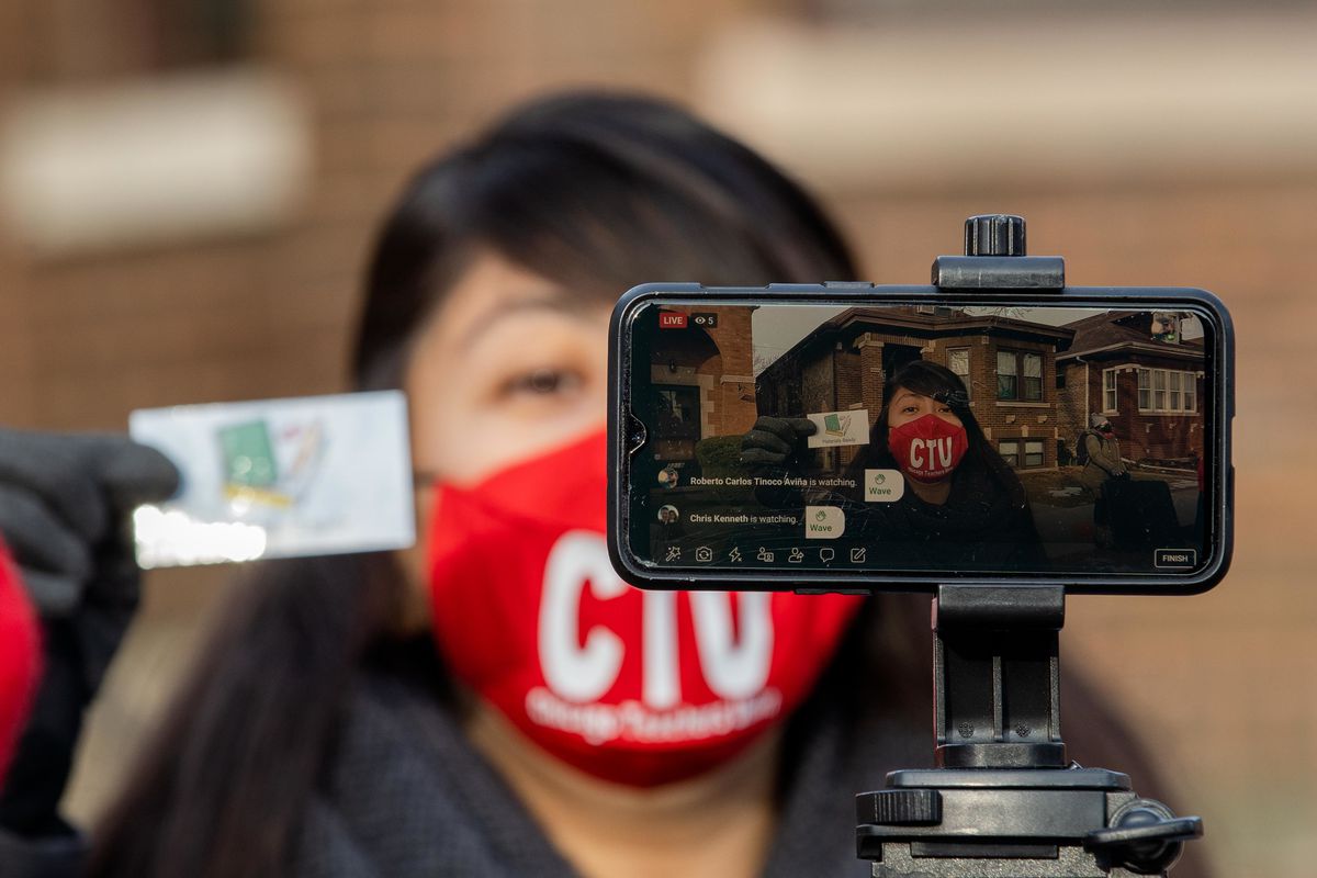 Linda Perales, who teaches kindergarten to 2nd grade students at Corkery Elementary School, livestreams a class outside Chicago Public Schools Board President Miguel del Valle’s home in the Belmont Cragin neighborhood Wednesday morning, Jan. 13, 2021.