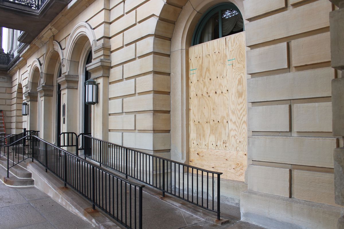 Plywood covers windows at the Illinois State Capitol on Friday.